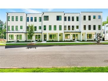 Modern townhomes with white exteriors, black framed windows, and well-manicured landscaping at 2144 Tidwell Ln # 2, Atlanta, GA 30318