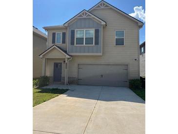 Charming two-story home with a two-car garage and a well-maintained front yard at 11600 Winston Dr, Hampton, GA 30228