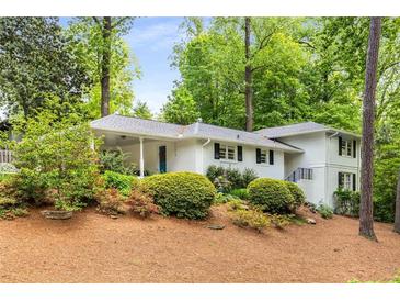 Charming one-story home with painted brick, landscaping, and mature trees, in a peaceful setting at 504 Kingswood Nw Ln, Atlanta, GA 30305