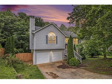 Charming split-level home with a two-car garage and freshly painted siding at 3694 Arrowhead Pl, Douglasville, GA 30135