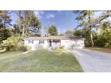 Charming single-story home featuring a well-maintained lawn, attached two car garage and inviting front porch at 3512 Valley Chase Ct, Lithonia, GA 30038
