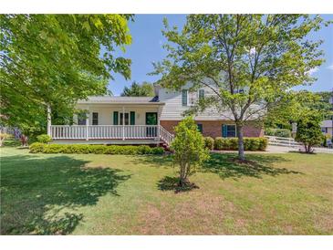 Charming two-story home with a welcoming front porch and well-manicured lawn at 2584 Gravitt Rd, Duluth, GA 30096