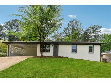 Charming white brick home with a well-manicured lawn and covered carport, perfect for suburban living at 3757 Cindy Dr, Douglasville, GA 30135