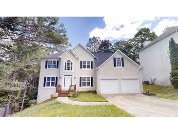 Charming two-story home with a two-car garage, black shutters, and a well-manicured front yard at 4912 Lightwood Nw Ct, Acworth, GA 30102