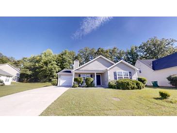 Charming single-story home featuring a well-manicured front yard, a concrete driveway, and a cozy, inviting entrance at 4954 River Overlook Way, Lithonia, GA 30038