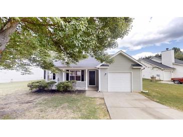 Charming single-story home with gray siding, attached garage, and a well-maintained front yard at 6614 Biscayne Blvd, Rex, GA 30273