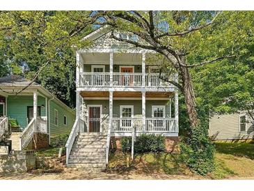 Charming two-story home with dual front porches surrounded by lush trees at 737 Cooper Sw St, Atlanta, GA 30315