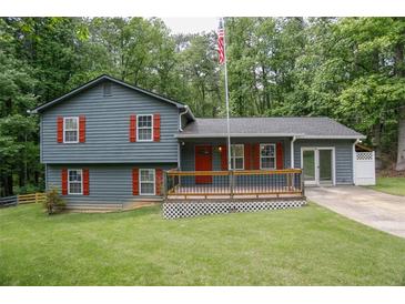 Charming two-story home featuring gray siding, red shutters, and a welcoming front porch at 1341 Timbercrest Ct, Lawrenceville, GA 30045