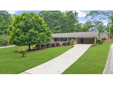 Charming home with a long driveway and lush green lawn at 1541 Eldonlas Ct, Stone Mountain, GA 30087