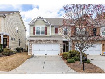 Inviting two-story home with a two-car garage and well-maintained landscaping at 1212 Lake Point Way, Suwanee, GA 30024