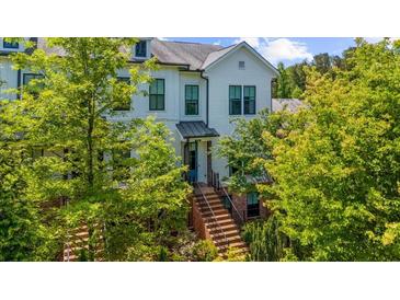 Charming white townhouse with well-manicured landscaping and a welcoming brick staircase leading to the front door at 219 Phillips Ln, Alpharetta, GA 30009