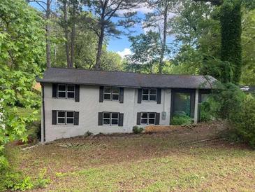 Two story exterior home with black shutters and lush surrounding landscaping providing curb appeal at 2851 Headland Dr, East Point, GA 30344