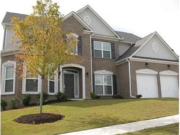 Charming two-story brick home with a well-manicured lawn and attached two-car garage at 947 Simonton View Ln, Lawrenceville, GA 30045