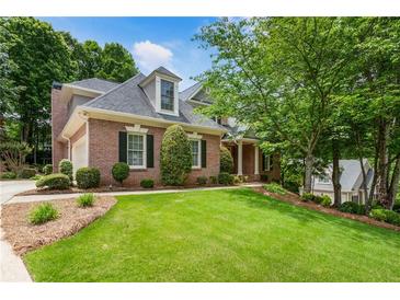 Charming brick home boasts a well-manicured lawn and lush landscaping, enhancing its curb appeal at 4561 Jenkins Way, Douglasville, GA 30135