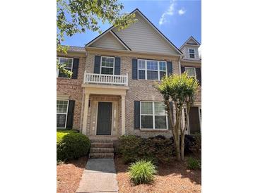 Beautiful brick townhouse with dark shutters and a charming front porch at 4540 Cold Spring Ct, Cumming, GA 30041