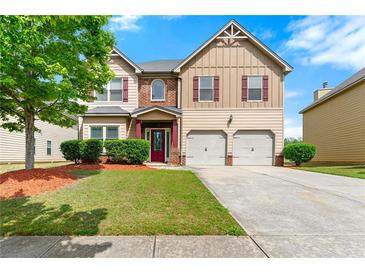 Inviting two-story home with a well-maintained lawn, two car garage, and appealing curb appeal at 1892 Ivy View Walk, Loganville, GA 30052