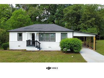 Charming single-story home with fresh white paint, black trim, and a covered carport at 1931 Selwyn Dr, Decatur, GA 30035