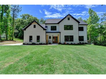 Charming two-story home boasts a brick facade, black accents, and a well-manicured lawn at 3599 Centerville Rosebud Rd, Snellville, GA 30039
