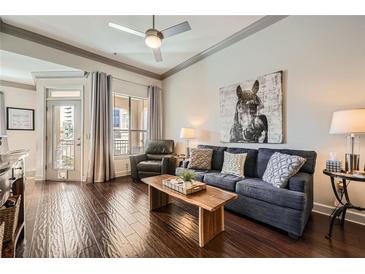 Inviting living room featuring hardwood floors, a ceiling fan, and comfortable seating at 3777 Peachtree Ne Rd # 1335, Atlanta, GA 30319