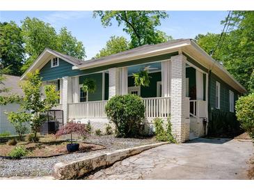 Charming bungalow featuring a quaint front porch, lush landscaping, and a welcoming curb appeal at 1545 Montreat Sw Pl, Atlanta, GA 30311