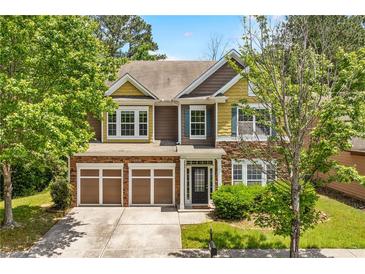 Charming two-story home featuring a two-car garage and beautifully landscaped front yard at 1125 Harvest Brook Way, Lawrenceville, GA 30043