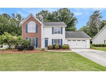 Charming two-story home with a brick accent and a well-manicured lawn at 175 Fenwyck Commons, Fayetteville, GA 30214