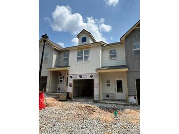 A modern, new construction townhouse showing the front exterior before landscaping is completed at 29 Benscot Dr, Austell, GA 30106