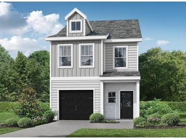 Charming two-story home with a black garage door and landscaped front yard, blending modern design with cozy appeal at 29 Benscot Dr, Austell, GA 30106