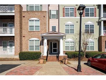 Apartment building exterior featuring a brick and siding facade with a covered entrance and well-maintained landscaping at 1975 Nocturne Dr # 2303, Alpharetta, GA 30009