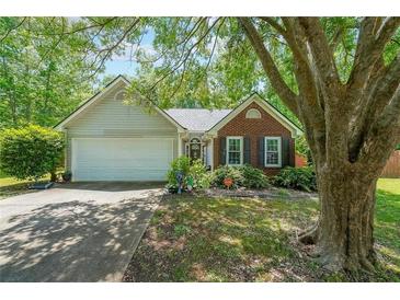 Charming single-Gathering home with brick and siding, features a well-maintained yard, and attached garage at 4872 Nature Trl, Austell, GA 30106