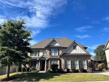 Charming two-story home featuring a well-manicured lawn and professional landscaping in a desirable neighborhood at 2506 Monta Vista Way, Hoschton, GA 30548