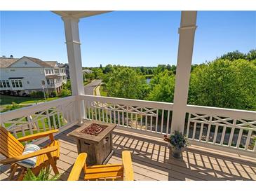Inviting balcony with wooden chairs, fire pit, and serene views of the neighborhood and lush greenery at 7120 Lullwater Rd, Cumming, GA 30040