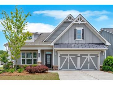 Charming one-story home with grey siding, manicured landscaping, and a welcoming two-car garage at 427 Bluffs View Ln, Canton, GA 30114