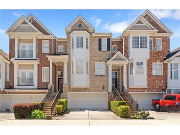 Charming townhomes featuring brick facade, individual garages, and manicured landscaping in a desirable neighborhood at 1266 Creekside Se Ter, Smyrna, GA 30082