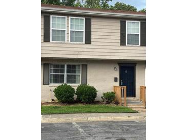 Exterior view of home featuring multiple windows and a well manicured lawn at 4701 Flat Shoals Rd # 37E, Union City, GA 30291