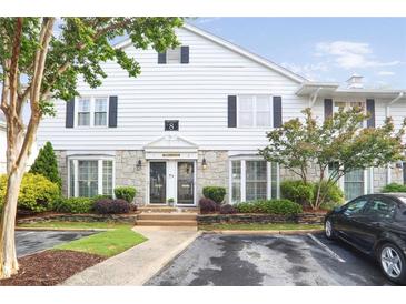 Charming townhouse with stone accents, bay windows, and well-maintained landscaping at 136 Peachtree Memorial Nw Dr # Nj2, Atlanta, GA 30309