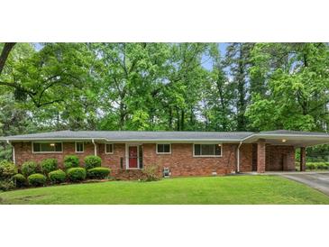 Charming single-story brick home with a well-maintained front yard and a covered carport at 1728 N Holly Ne Ln, Atlanta, GA 30329