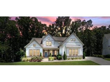 Beautiful white two-story home with well-manicured lawn and mature trees at sunset at 2861 Digna Ct, Acworth, GA 30101