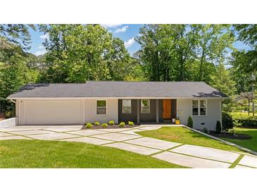 Charming single story home with modern curb appeal, featuring a brick facade and well-manicured lawn at 1377 Oak Grove Dr, Decatur, GA 30033