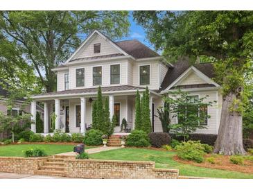 Charming two-story home with manicured lawn, brick accents and inviting front porch at 194 Locust Nw St, Marietta, GA 30064