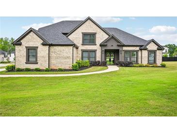 Beautiful brick home with a manicured lawn and mature landscaping at 3991 Perry Pass, Lithonia, GA 30038