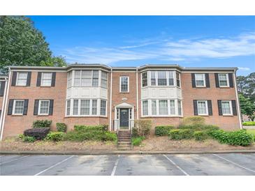 Charming brick townhouse with black shutters, trimmed windows and well-kept landscaping at 2349 Henderson Mill Ne Rd # 2, Atlanta, GA 30345