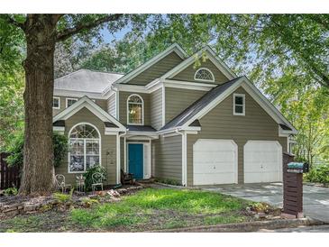 Charming home with a two-car garage, landscaped yard, and a welcoming blue front door at 2735 Royal Blf, Decatur, GA 30030