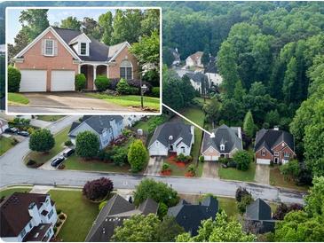 Aerial view of a brick home surrounded by lush greenery in a residential neighborhood at 3082 Monarch Pine Dr, Peachtree Corners, GA 30071