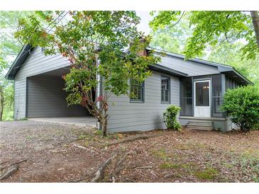 Quaint home featuring an attached carport and screened-in porch at 147 Harris Loop, Dallas, GA 30157