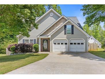 Charming home with a two-car garage and inviting front yard, offering curb appeal at 109 Riley Way, Canton, GA 30115