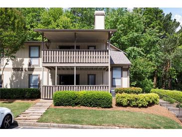 Two-story condo with double decks and steps leading up to a well-manicured lawn and mature trees at 807 Woodcliff Dr, Sandy Springs, GA 30350