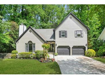Charming two-story home with a landscaped front yard and a two-car garage at 1810 Fairoaks Pl, Decatur, GA 30033