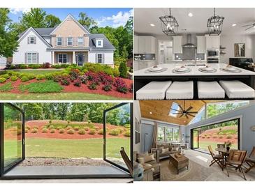 Beautiful two-story home with manicured lawn and flower beds at 5875 Windjammer Pt, Cumming, GA 30041