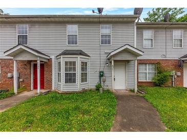 Charming townhouse with brick accents and covered entryway, offering a cozy and inviting curb appeal at 8541 Westchester Dr, Douglasville, GA 30134